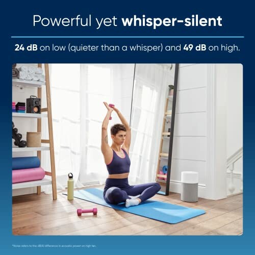 Person practicing yoga at home with exercise equipment nearby.