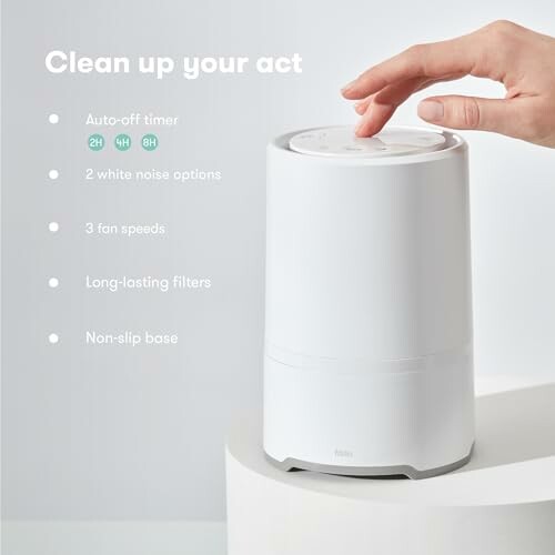 Hand touching white humidifier with features listed: auto-off timer, white noise options, fan speeds, long-lasting filters, non-slip base.