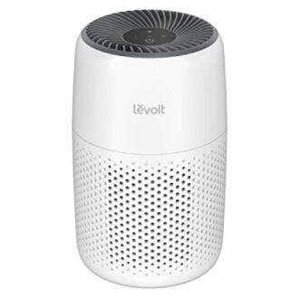 Levoit air purifier with a cylindrical design and perforated exterior.