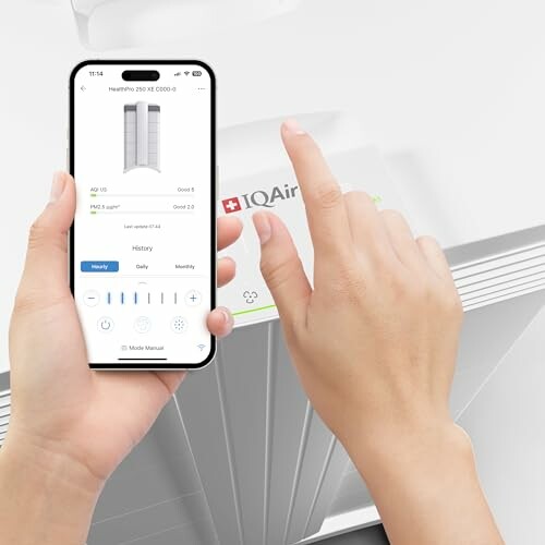 Person using smartphone app to control air purifier
