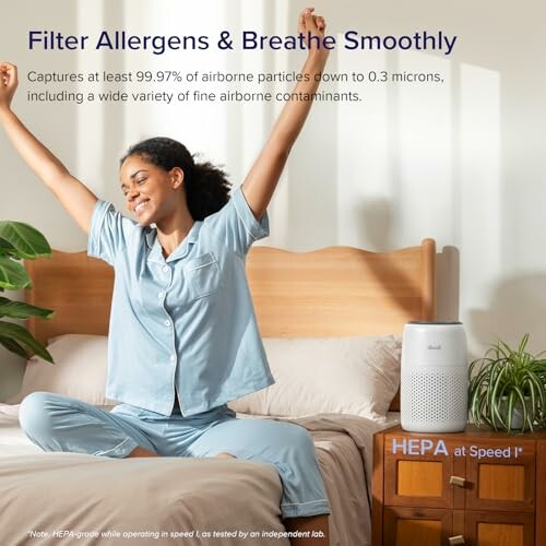Woman stretching on bed with air purifier nearby.